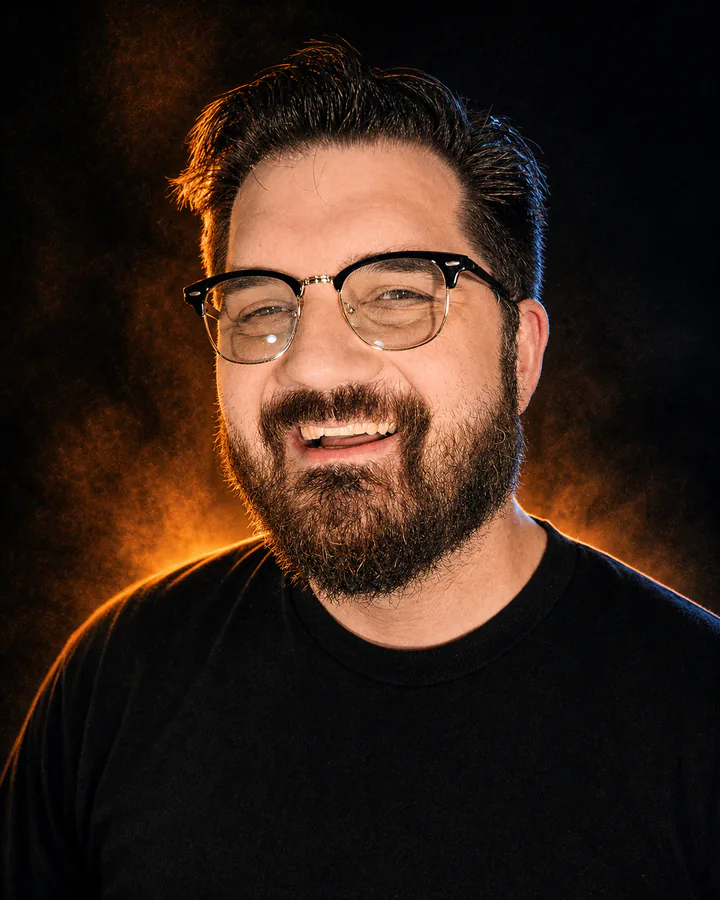 Glenn C. Hahn smiling in dramatic amber and blue light