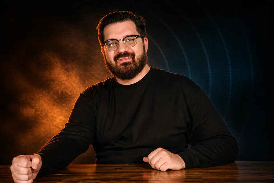 Glenn C. Hahn seated decisively at a studio desk